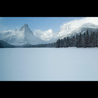 Winter view from Glenns Lake of Mount Kitt, Pyramid, Cathedral, and Stoney Indian Peaks in Glacier National Park